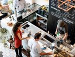 A coffee shop with customers picking up coffee