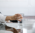 person holding a glass of water