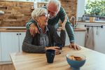 man and woman laughing in kitchen