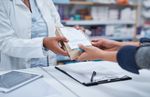 Two people exchanging over the counter medication.